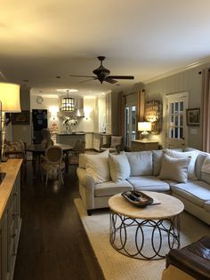 a living room filled with furniture and a ceiling fan