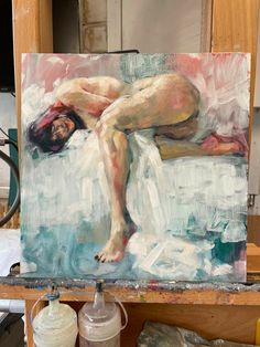 a painting of a naked woman laying on a bed