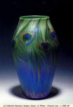 a blue and green vase sitting on top of a table