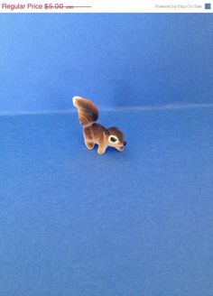 a small figurine of a dog on a blue surface