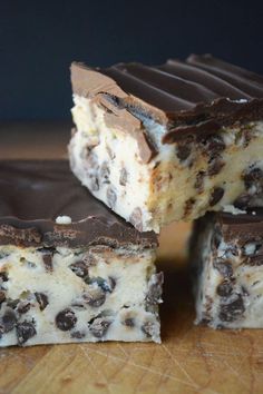 four pieces of chocolate chip cheesecake on a wooden table