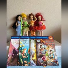 three disney princess dolls are on top of each other in front of the books they're reading