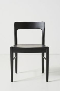 a black chair sitting on top of a white floor