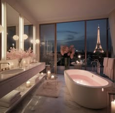 a bathroom with candles lit up in front of the window and an oval bathtub