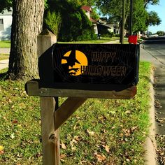 a halloween mailbox sitting on the side of a road