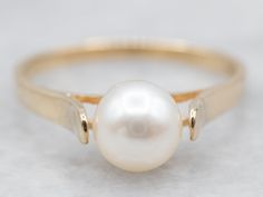 This classic yellow gold solitaire ring with a lustrous pearl at its center exudes timeless elegance. Expertly crafted to the highest standards, this ring is sure to become a treasured heirloom.Metal: 14K Yellow GoldGem: PearlGem Measurements: 6.2 mm, RoundRing Size: 6.50Marks: "14KWH" Stamped on the inside band Pearl Ring Design, Vintage Pearl Ring, Pearl Rings Vintage, Opal Solitaire Ring, Yellow Gold Solitaire Ring, Sapphire Solitaire Ring, Right Hand Ring, Woven Ring, Gold Pearl Ring