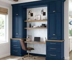 a room with blue cabinets and a desk in the center, along with a chair