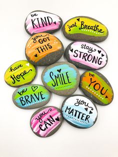 painted rocks with different sayings on them