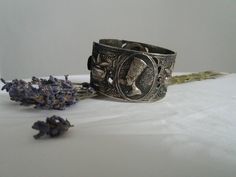 Vintage 1960s costume bracelet ,silvertone metal egyptian motifs. Measures length :8'' width: 2'' condition: excellent Shipping Is Avaliable Worldwide. Every item is carefully shipped Priority via Air Mail - shipping takes from 7 to 14 working days, depending on your location. Shipping includes Tracking. Come and check out our shop to see all items! https://www.etsy.com/shop/Themagicstories?ref=hdr_shop_menu Thanks! Note: m i n t : pristine with no signs of wear- possibly deadstock e x c e l l e Nickel-free Antique Silver Metal Cuff Bracelet, Silver Etched Metal Cuff Bracelet, Etched Silver Metal Cuff Bracelet, Handmade Antique Silver Metal Cuff Bracelet, Silver Metal Cuff Bracelet For Ceremonial Occasions, Ceremonial Silver Metal Cuff Bracelet, Vintage Nickel-free Antique Silver Cuff Bracelet, Vintage Silver Bangle, Collectible, Vintage Silver Bangle For Collectors