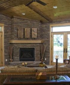 a living room filled with furniture and a fire place in the middle of a room