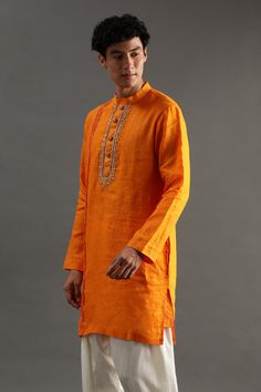 Orange linen kurta with gota and zardosi hand embroidered placket. Comes with white pyjama.
Components: 2
Pattern: Hand embroidered
Type Of Work: Gota, Zardosi
Neckline: Band collar
Sleeve Type: Full
Fabric: Linen
Color: Orange
Other Details: 
Closure : Front buttons
Occasion: Mehendi and Puja,Sangeet - Aza Fashions White Pajamas, Linen Color, Fashion App, Band Collar, Pyjama Set, Aza Fashion, Sleeve Type, Color Orange, Hand Embroidered