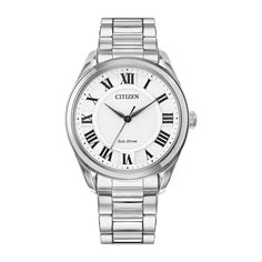 Make a statement wearing this sophisticated, classically styled Arezzo ladies’ watch by Citizen. This sleek 35mm watch – with its white dial, silver stainless steel bracelet band with deployment clasp and bold Roman numeral markers – stands out from the crowd while remaining understated. This is a modern twist on a classic design, featuring a genuine Sapphire crystal and Citizen’s Eco-Drive technology that sustainably powers itself by light. This women’s classic dress watch in stainless steel fe Sleek Watch, Eco Drive Watches, White Dial Watch, Helzberg Diamonds, Citizen Watch, Citizen Eco, White Watch, Eco Drive, Roman Numeral