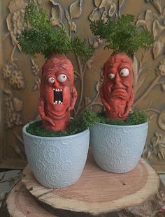 two planters with fake heads on top of them