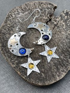 I've created these sparkly and fun-filled whimsical earrings in a celestial theme, featuring two 6mm round gemstones of your choosing. The gemstones have a glowing hue when turned in lighting and are reflective, luminous and magical! The moons are 1 and 1/4 inches in diameter and I've hand-cut two small 14K gold-filled stars and soldered them onto the moons, did the same with two sterling silver stars, and each earring has one 2mm solid 14K bead near the hooks.  The stars beneath are 1/2 inch in Whimsical Earrings, Celestial Theme, Crescent Moon And Star, Moon And Star Earrings, Dope Jewelry, Small Jewelry Box, Celestial Jewelry, Moon And Star, Funky Jewelry