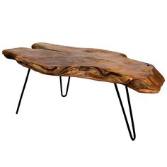 a wooden table with black hairpin legs and a large slab of wood on top