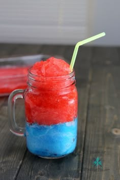 a red, white and blue drink in a mason jar with a straw sticking out of it