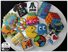 a white plate topped with lots of decorated cookies