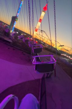 the ferris wheel is lit up at night with colorful lights in the sky behind it