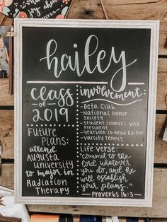 a chalkboard sign with the names of different classes on it and other items around it