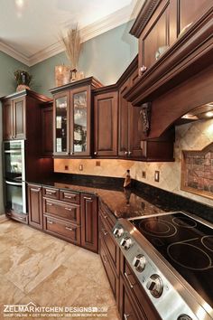 a kitchen with brown cabinets and marble counter tops is pictured in this image from the front view