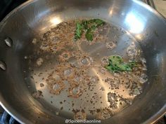 a metal pan filled with food on top of a stove