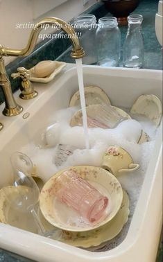 a sink filled with dirty dishes and water