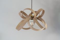 a wooden light fixture hanging from a ceiling