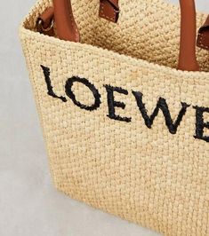 Warm-weather acessorizing is easy with this compact tote bag from Loewe. Crafted from raffia, the rectangular style has leather top handles and logo embroidery on the front..Made in Spain.Detachable shoulder strap, Top handles.Designer color name: Natural/Black.Material: raffia.Comes with dust bag.Trim: leather.Closure: open top.Height 21cm-8.5'.Width 17cm-6.5'.Depth 6cm-2.5'.Length of handles 27,5cm-11'.Min. length shoulder strap 108,5cm-42.5'.Max. length shoulder strap 128,5cm-50.5' Luxury Summer Bag With Rolled Handles, Modern Rectangular Bag With Rolled Handles, Rectangular Shopping Bag With Rolled Handles, Casual Bags With Rolled Handles For Errands, Square Shopping Bags With Rolled Handles, Natural Color Double Handle Bag With Handle Drop, Natural Double Handle Bag With Handle Drop, Modern Tan Bags For Summer, Tan Top Handle Bag With Braided Handles