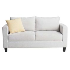 a white couch with two pillows on it