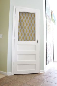 a white door with a yellow wallpaper behind it