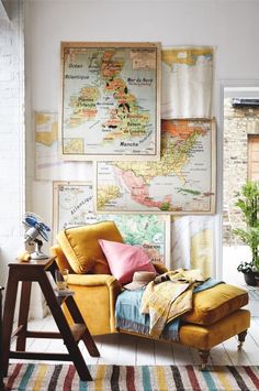 a yellow chair sitting in front of a map on the wall next to a window