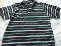 NEW Men's size Medium Black Aqua & Gold Stripe Polo Shirt NEW men's stripe polo shirt in black, gold and aqua stripes.  Short sleeve and a black knit collar. Perfect with jeans or under a jacket. Shipping and handling is only $5.99. Black Casual Polo Shirt With Striped Collar, Casual Black Polo Shirt With Striped Collar, Mens Stripes, Striped Polo Shirt, Gold Stripes, New Man, Black Knit, A Jacket, Knit Collar