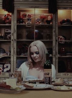 two women sitting at a table with plates of food in front of them