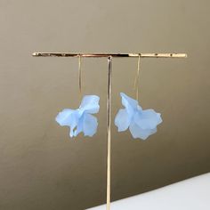 Cyclamen Petal Drop Earrings are out-of-this-world beautiful earrings that feature petal like shapes in soft, ethereal tones. Light and airy, these earrings will add the perfect touch of floral statement to any outfit! About 3 inches long LAST CHANCE = FINAL SALE Summer Light Blue Pierced Earrings, Whimsical Blue Drop Earrings, Blue Flower Shaped Earrings For Summer, Blue Flower-shaped Summer Earrings, Blue Spring Earrings For Pierced Ears, Delicate Blue Flower Earrings With Ear Wire, Blue Spring Earrings, Elegant Light Blue Earrings For Summer, Light Blue Drop Earrings For Summer