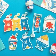 various stickers on a blue surface with an ice cream cone and teddy bear images