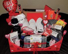 a valentine's day gift basket on a bed