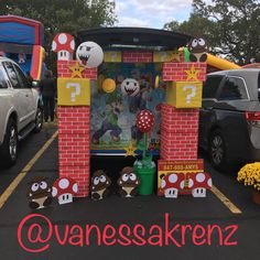 a display in the parking lot for mario and luigi's birthday party at an amusement park