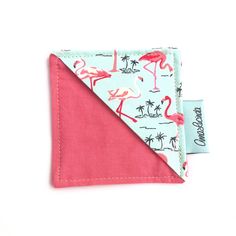 a pink and blue bandana with flamingos on the front is folded in half