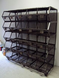 a large metal shelf filled with lots of baskets on top of white floor next to wall