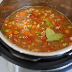 a pot filled with soup sitting on top of a stove