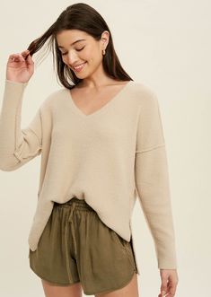 Cozy meets simple in the Susana Brushed Knit Top in oatmeal that features reverse seams.   Brushed sweater knit Side slits Reverse seams  High-low hemline  -Contents  100%Nylon    Model is wearing small size  -Approximate measurements are as follows  Small:Length:23 1/2" Bust:44 1/2"   Medium: Length 24" Bust:46 1/2"  Large: Length:24 1/2" Bust 48 1/2" Chic Soft Knit V-neck Sweater, Beige V-neck Sweater For Fall Loungewear, Beige Soft Knit V-neck Sweater For Fall, Oversized Neutral V-neck Sweater, Cream Soft Knit V-neck Sweater For Fall, Cozy Soft Knit V-neck Sweater For Layering, Cozy V-neck Knit Top For Fall, Beige Textured Knit V-neck Sweater, Cozy V-neck Top With Soft Texture