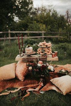 a table with pillows and candles on it