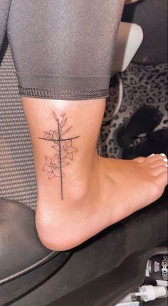 a person with a cross tattoo on their foot