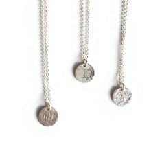 These Silver Zodiac Necklaces, have a single delicate charm of sterling silver hand stamped with the zodiac sign of your choice. The hammered variant gives these charms add a slight texture that catches the light.Wear as simple necklace alone or as a layering piece with my constellation pendant or one of your own pieces. Select your preferred length or an adjustable chain with closures at 18", 19" and 20".Charm diameter: 9mm"Thickness: 20 gaugeEach pendant comes attached to a jewelry card highli Sterling Silver Zodiac Sign Charm Necklace For Gift, Sterling Silver Zodiac Sign Charm Pendant Necklace, Sterling Silver Zodiac Sign Pendant Charm Necklaces, Sterling Silver Zodiac Sign Pendant Necklace, Minimalist Stamped Sterling Silver Charm Necklaces, Symbolic Hand Stamped Sterling Silver Necklaces, Minimalist Stamped Sterling Silver Charm Necklace, Dainty Silver Stamped Charm Necklace, Dainty Stamped Silver Charm Necklace