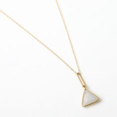 This necklace features a triangle-shaped gemstone pendant edged in 14 karat gold fill, available in multiple gemstones, including moonstone, amethyst, labradorite, and black onyx. The pendant measures 1" in length, which includes the 1/2" triangle gemstone. The triangle symbolizes strength, power, and stability, making it a perfect choice for a pendant that will be worn close to the heart. The gemstones also carry their own unique symbolism, with moonstone representing intuition and new beginnin Minimalist Brass Necklace With Gemstone, Minimalist Brass Gemstone Necklace, Minimalist White Triangle Jewelry, Earrings Quotes, Bracelet Quotes, Necklace Quotes, Jewelry Quotes, Triangle Necklace, Jewellery Inspiration