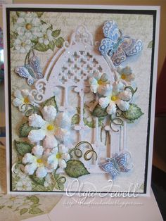 a close up of a card with flowers and butterflies on it's front side