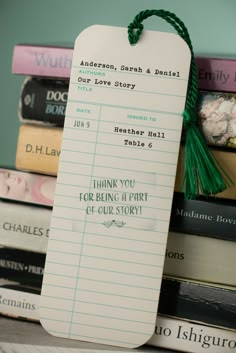 a bookmark sitting on top of a pile of books