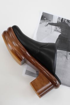 Artfully hand carved double wooden platform heel, 100% soft leather uppers and leather lined, lacquered 1 3/4" to 3" platform heel. Ultra comfortable, padded, all-day-wearable, wood clog. Free of staples. If between sizes we suggest going up a half size. Sedia is the Italian word for chair. Made fairly in Peru. Black Clogs With Sculpted High Heel, Black Closed Toe Clogs With Sculpted Heel, Black Leather Clogs With Sculpted Heel, Leather Sole High Heel Clogs For Work, High Heel Clogs With Leather Sole For Work, Modern Clogs With Padded Heel, Leather Mules With Wooden Low Heel, Modern Black Clogs With Rubber Heel Cap, Modern Black Clogs With Sculpted Heel