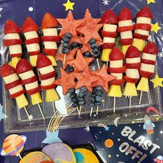 an american flag made out of strawberries and blueberries on skewers with stars