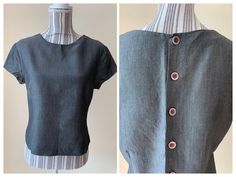 "This is a vintage 80s grey back button up top for women, made in Italy. This elegant classic short sleeve shirt has simple silhouette, crew neck and back button up closure. It is made of viscose - wool blend fabric (80% viscose, 10% mohair wool, 10% wool). This stylish office top is size 46 Italy. It fits like size M/L.  Please check the measurements below. Era: 80s Brand: Le Group Collection Country of origin: Italy Condition: beautful condition with some signs of wear - the fabric has some texture - you can see some tiny bumps here and there and some fine lines which look like pulled threads. I am unsure if these are signs of wear or the texture of the fabric.   Size: 46 Italy, fits like M/L , please check the measurements below. Measurements: Shoulder to shoulder: 16.9\" / 43 cm Bust: Fitted Button-up Tops With Button Back, Casual Fitted Top With Button Back, Fitted Crew Neck Blouse With Buttons, Stylish Capsule Wardrobe, 80s Shorts, Wardrobe Minimalist, Capsule Wardrobe Minimalist, Italy Fits, Office Top